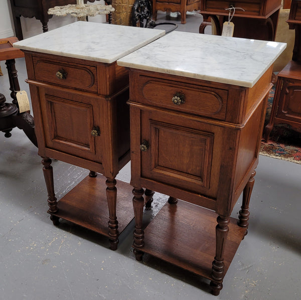 Antique French Oak Henry II white marble top bedside cabinets. They have one drawer and cupboard a long with an open shelf at the bottom. Sourced from France and in good original detailed condition.