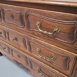 French Provincial Oak three drawer wooden top commode. It has elegant carvings and handles. It has been sourced from France and is in good original detailed condition.