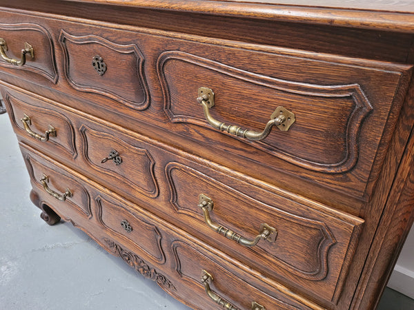 French Provincial Oak three drawer wooden top commode. It has elegant carvings and handles. It has been sourced from France and is in good original detailed condition.