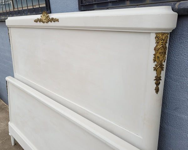 French Louis 16th style chalk painted queen size bed with gilt decorative mounts and includes custom slats. It has been sourced from France and in good original condition.