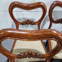 Set of six Victorian style balloon back chairs with lovely carved detail on legs and backs. Cream coloured upholstered seats and fabric is in good condition with some sign on use. Overall chairs are in good original detailed condition.