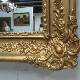 A French transitional Louis XV/Louis XVI style, gilded hanging wall mirror. In good restored condition.