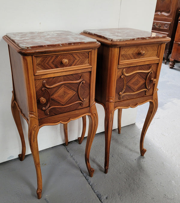 Pair French Walnut Louis XV style Bedside Cabinets with inset rouge carrera marble tops and parquetry inlay. Consisting of one drawer and one cupboard on very elegant legs. Circa: 1900's.