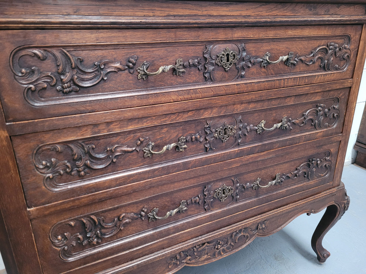 French Oak Louis XV style marble top chest of three drawers. It has beautiful carvings on the drawers with lovely decorative handles all toped with a stunning black and white marble top. In good original detailed condition.