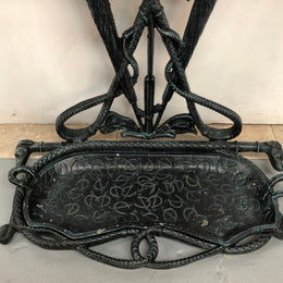 A black cast iron umbrella stand displaying a horse in the middle with four dogs on the side. In good original condition.