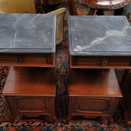Pair of unusual transitional fruit wood marble top bedside cabinets. They have been sourced from France and are in good original detailed condition.
