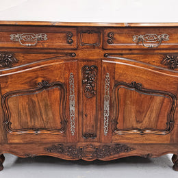 Attractive French Walnut Louis XV style two door two drawer sideboard featuring beautiful carving.  Circa: 1930's. It has been sourced from France and it is in good original detailed condition.
