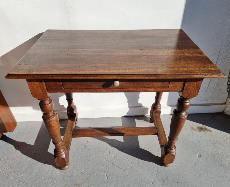Rustic French Oak side table or desk with single drawer and turned legs. In good original detailed condition.