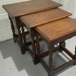 Tudor style English dark Oak nest of three tables. They are in good restored condition.