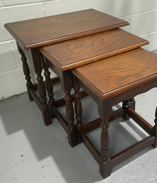 Tudor style English dark Oak nest of three tables. They are in good restored condition.