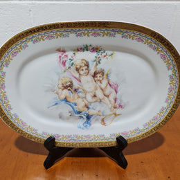 Beautiful T. Limoges porcelain decorative oval plate depicting 3 cherubs with gold edging. In good original condition.
