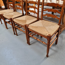 Charming set of eight Cherry Wood ladder back dining chairs. They are in good original detailed condition.