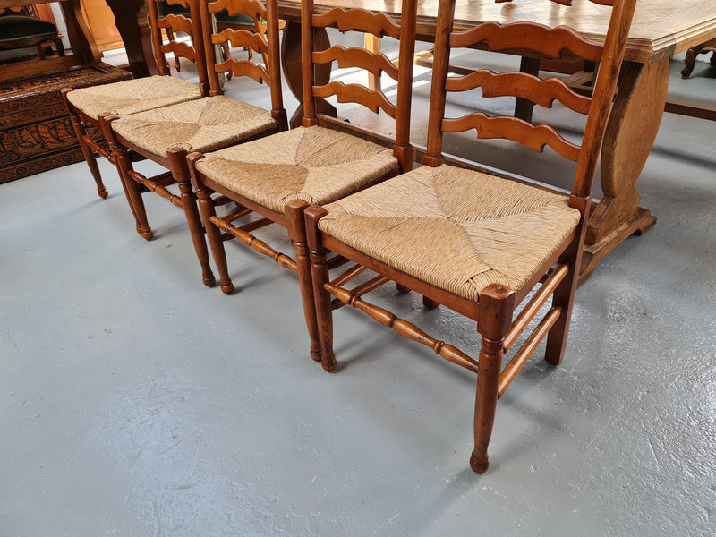 Charming set of eight Cherry Wood ladder back dining chairs. They are in good original detailed condition.