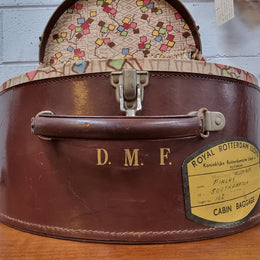Charming solid leather hatbox with patterned fabric interior and two interior pockets. Interior stamp is for The Mutual Store Melbourne. Bears paper stamps for P&O Cruise Passenger” & “Peninsular  the top and D.M.F. in gold near the handle. Circa: Early 1900’s. 43 cm across and H:21 cm the lid.