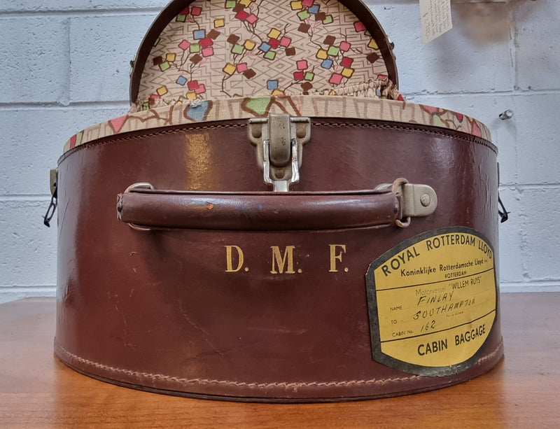 Charming solid leather hatbox with patterned fabric interior and two interior pockets. Interior stamp is for The Mutual Store Melbourne. Bears paper stamps for P&O Cruise Passenger” & “Peninsular  the top and D.M.F. in gold near the handle. Circa: Early 1900’s. 43 cm across and H:21 cm the lid.