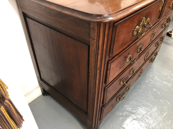 Stunning French 18th Century Walnut commode with beautiful hardware. In good original detailed condition.
