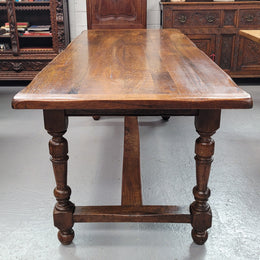 Rustic French Oak stretcher based farmhouse dining table that comfortably seats 6-8 people. It has been sourced from France and is in good original condition.
