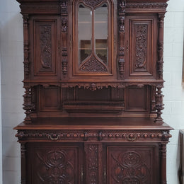 Spectacular French Antique Walnut Renaissance Style buffet with amazing detailed carvings. Plenty of storage space with five cupboards and two large drawers. The three top cupboards open up to two adjustable shelves in each section and the two bottom drawers open up to one large fully adjustable shelve. In good original detailed condition. Circa 1860.