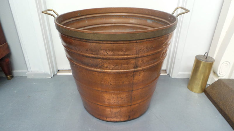 A fabulous French rustic antique copper and brass two handled bucket. Has loads of character and would make a great bucket for firewood. It is in very good original condition