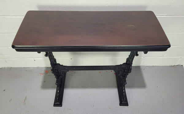 Late Victorian English Mahogany and cast iron base pub table. The foundry maker name is on the base and it is in good original detailed condition.