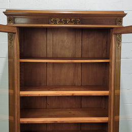 French Walnut two door bookcase with adjustable shelves and lovely ormolu details. It is in good original detailed condition.