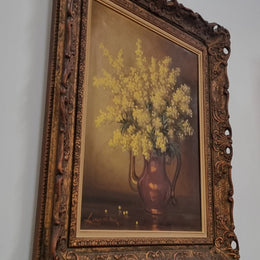 French floral still life painting oil on canvas of Wattle in a vase in a stunning decorative frame in good condition. Signed by artist and has been sourced from France.