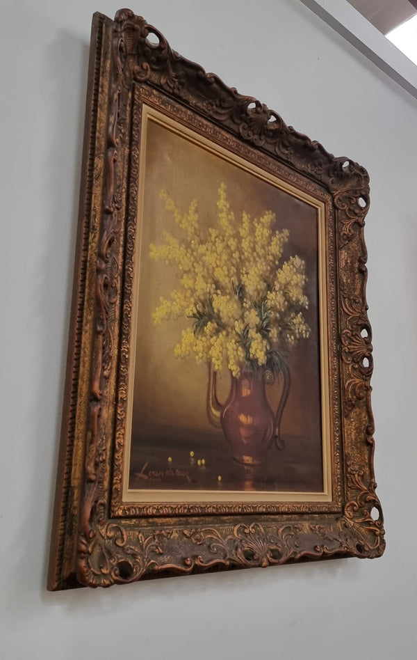 French floral still life painting oil on canvas of Wattle in a vase in a stunning decorative frame in good condition. Signed by artist and has been sourced from France.