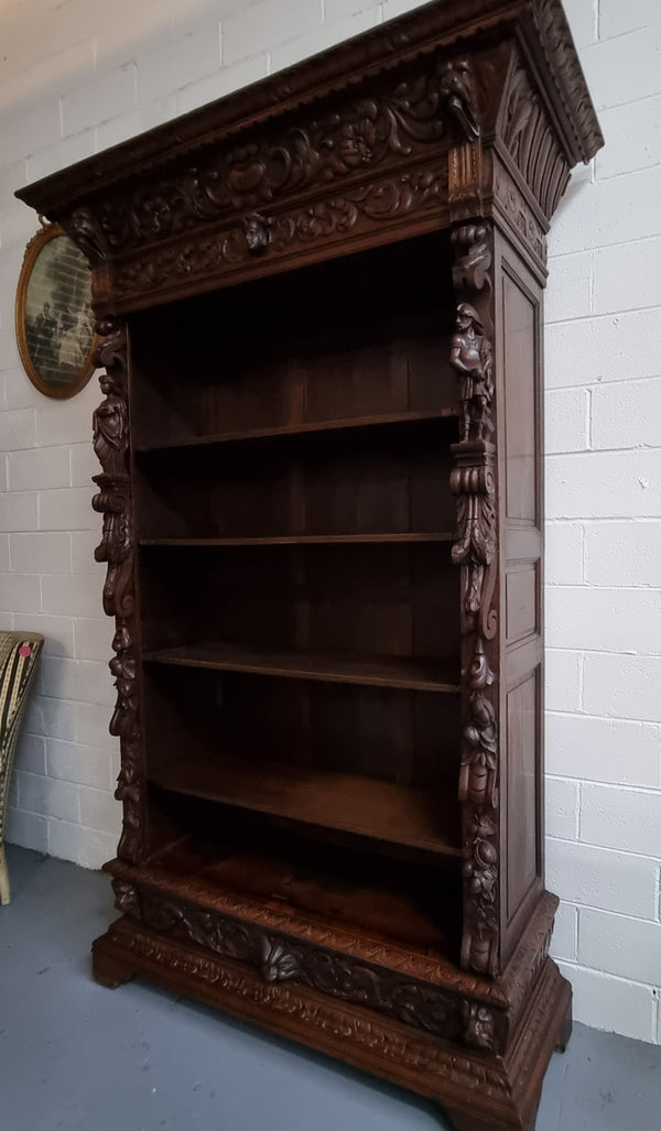 Amazing dark Oak heavily carved Gothic style bookcase with lovely details and adjustable shelves in good original detailed condition. The doors currently have no glass which can easily be added or be left  with open shelves.