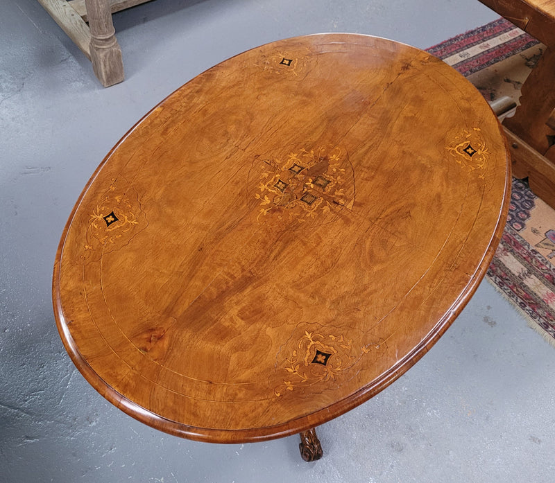 Victorian Walnut oval beautifully inlaid occasional table with bird cage undercarriage. It is in good original detailed condition and it has been sourced locally.