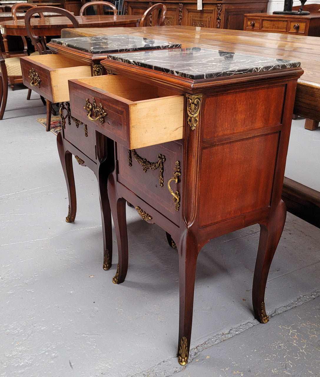 Appealing Louis XV style high quality bedside cabinets with black Portoro marble top and bronze mounts. They have been sourced from France and are in good original condition.