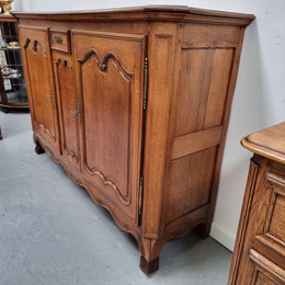 Amazing French Oak early 19th Century two door sideboard with one drawer and two fixed shelves. Sourced from France and in good original detailed condition.