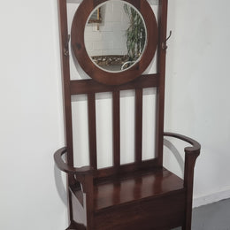 Blackwood Federation hall stand of pleasing narrow proportions. Beautiful round mirror with four lovely hooks and a lift up sit for added storage. In good original condition.