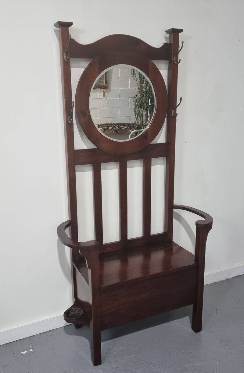 Blackwood Federation hall stand of pleasing narrow proportions. Beautiful round mirror with four lovely hooks and a lift up sit for added storage. In good original condition.