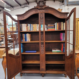 Substantial French Oak Louis 15th Style large two door bookcase. Adjustable shelves and very decorative carving. In good original detailed condition.