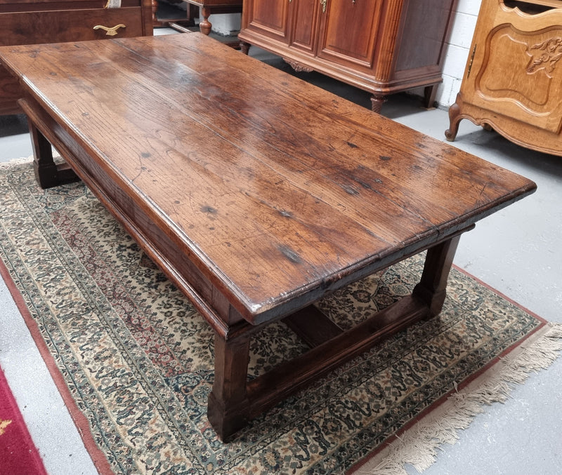 Impressive large size rustic French Oak coffee table with two drawers on a stretcher base. In good original detailed condition and sourced from France.