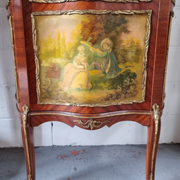 Lovely Vintage French Louis XVth style Vitrine. It has lovely gilt mount details and two glass shelves with room also for storage in good original condition.