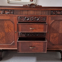 Art Deco Tudor style Oak sideboard with decorative carved detail. Plenty of storage space with two cupboards and four drawers. It has been sourced locally and is in good original detailed condition.