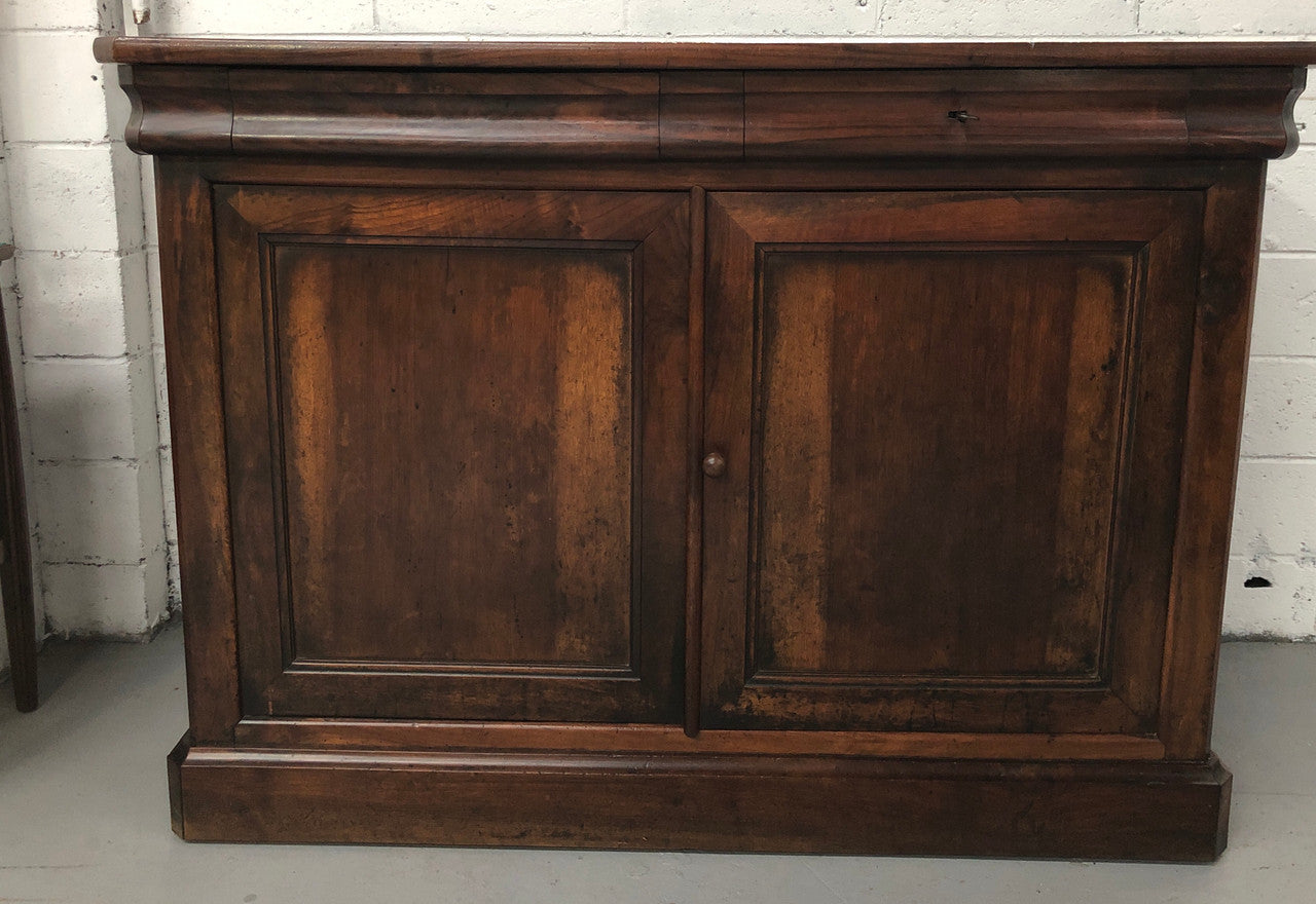 Lovely Early 19th Century French Walnut counter/sideboard with two drawers and cupboards for all your storage needs. It is in good original detailed condition.