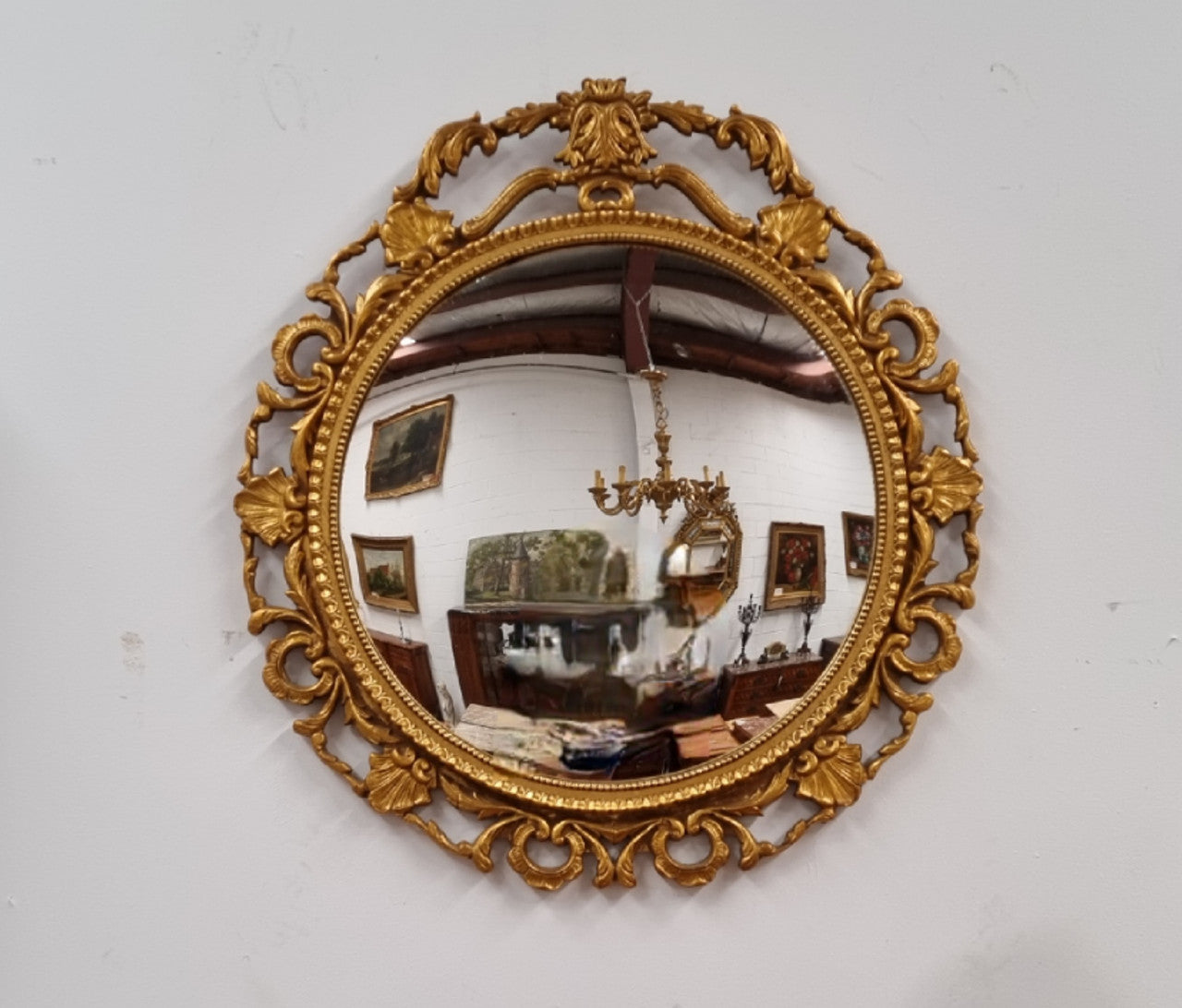 Vintage large round ornate convex mirror. Lovely gilt decoration around and is in good original condition.