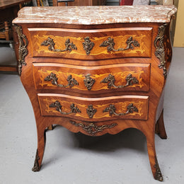 Antique French Louis XV style compact three drawer marble top commode with marquetry inlay and ormolu mounts. Sourced from France and in good original detailed condition.