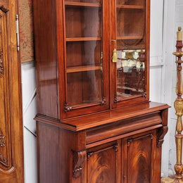 Mid 19th Century Australian Cedar and Flame Cedar tall bookcase. The top has two glass doors that open up to three adjustable shelves followed by a drawer in the middle and finishes with two beautiful wooden doors that open up to a fixed shelf. In good original detailed condition and has been sourced locally.