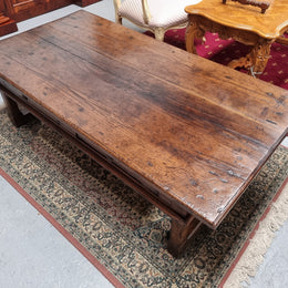 Impressive large size rustic French Oak coffee table with two drawers on a stretcher base. In good original detailed condition and sourced from France.
