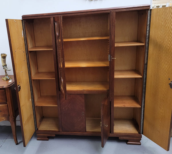 Stylish French Art Deco Oak bookcase with heaps of storage space and shelves. Middle section has two glass display doors. In good original detailed condition.