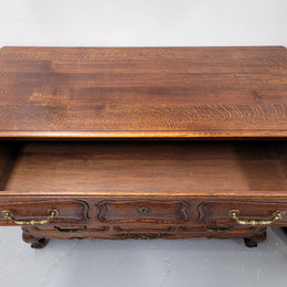 French Provincial Oak three drawer wooden top commode. It has elegant carvings and handles. It has been sourced from France and is in good original detailed condition.