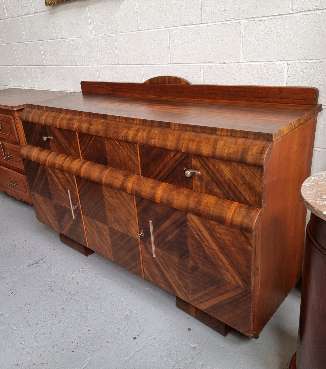 Vintage Walnut Art Deco “Waterfall” sideboard buffet with two drawers and two doors. It is in good original condition and has been sourced locally.