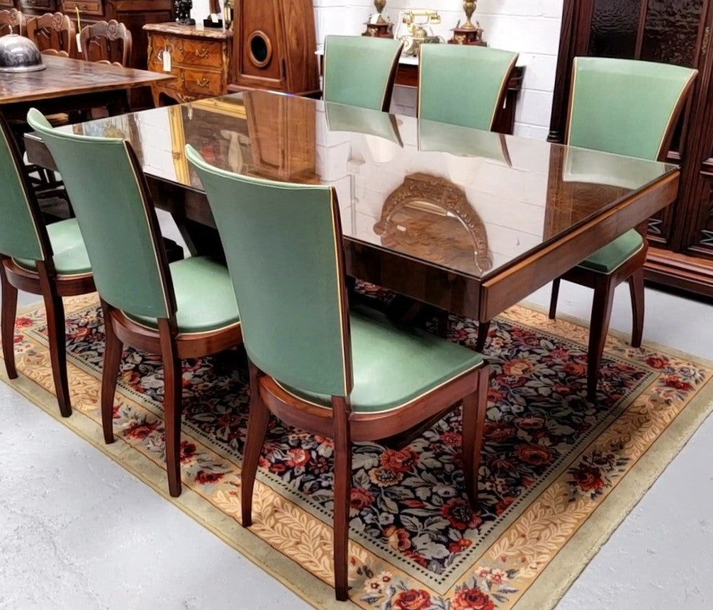 French Art Deco Figured Walnut dining table and six chairs. This stylish table also comes with a glass top and can be used with or without it. The chairs are very comfortable and the table can also fit another two chairs at either end making it a 6-8 seater. The table is in good original detailed condition with character marks to the top of table as shown in the pictures. This table and six chairs have been sourced locally.
