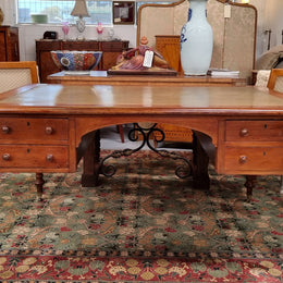 English Cedar full partners desk with attractive tooled leather top, four drawers either side and on caster wheels.  In good original detailed condition.