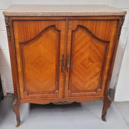 Stunning compact Louis 15th style two door walnut cabinet with ormolu trim and marble top. It is in good original condition.