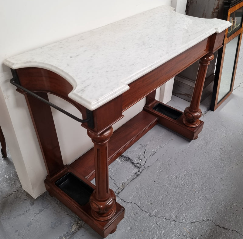 Classic Victorian mahogany console table with white marble top, one drawer and accommodation for sticks/umbrellas. In good original detailed condition.