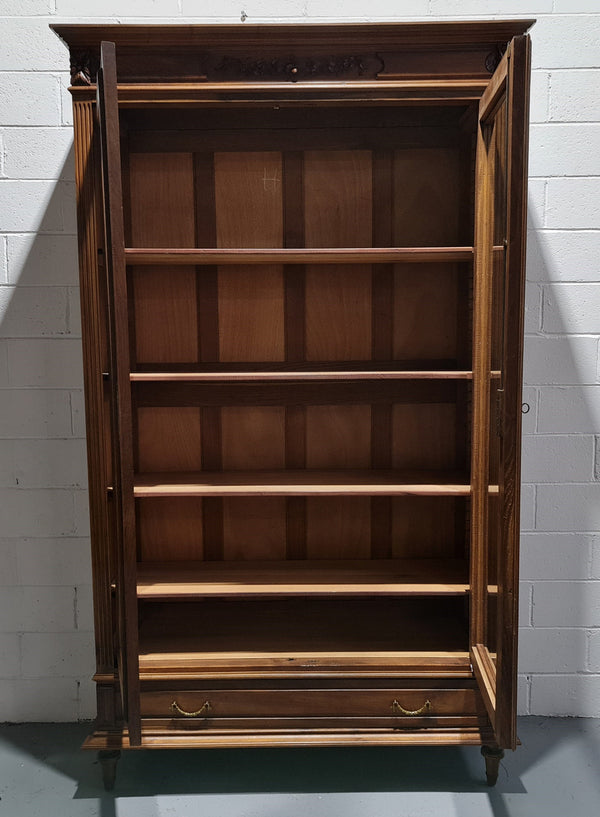 Stunning French Henry II style Walnut two door bookcase. In good original detailed condition.